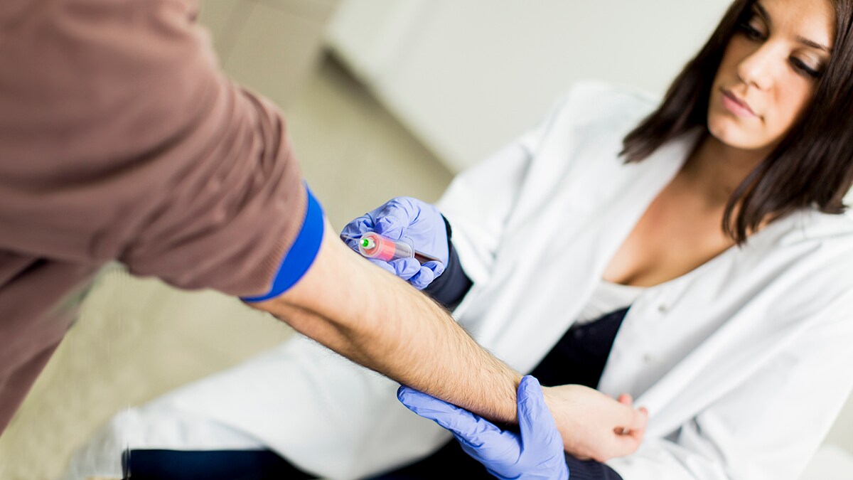 Man getting his blood drawn for a cholesterol screening test.