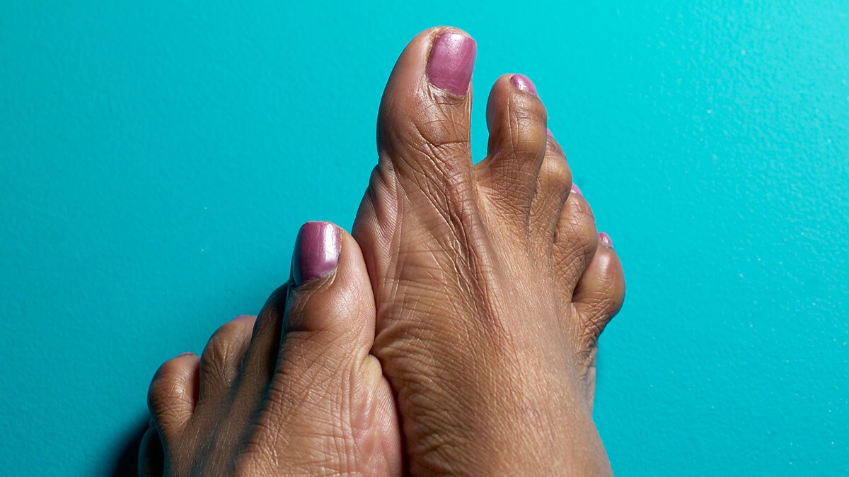 African American woman’s feet with pink nail polish