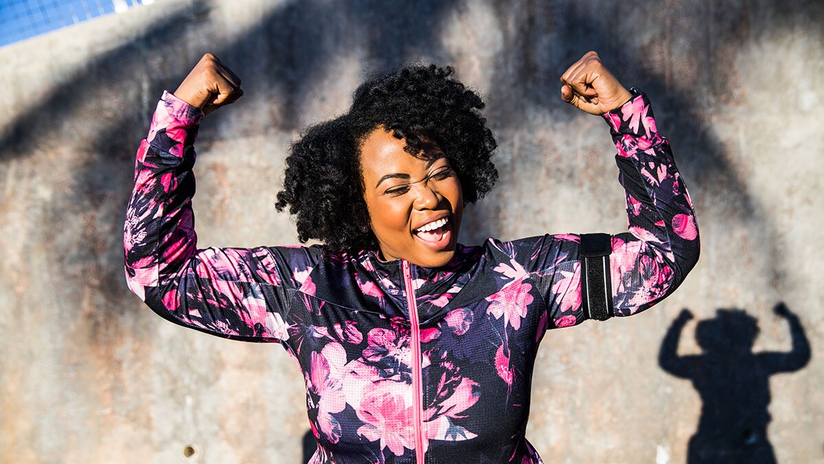 African American woman wearing exercise clothes celebrating