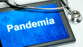 Photo of a tablet with the word "pandemic" on it.