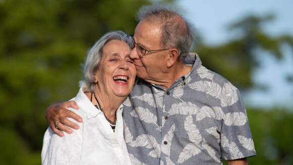 Older adult couple smiling and hugging